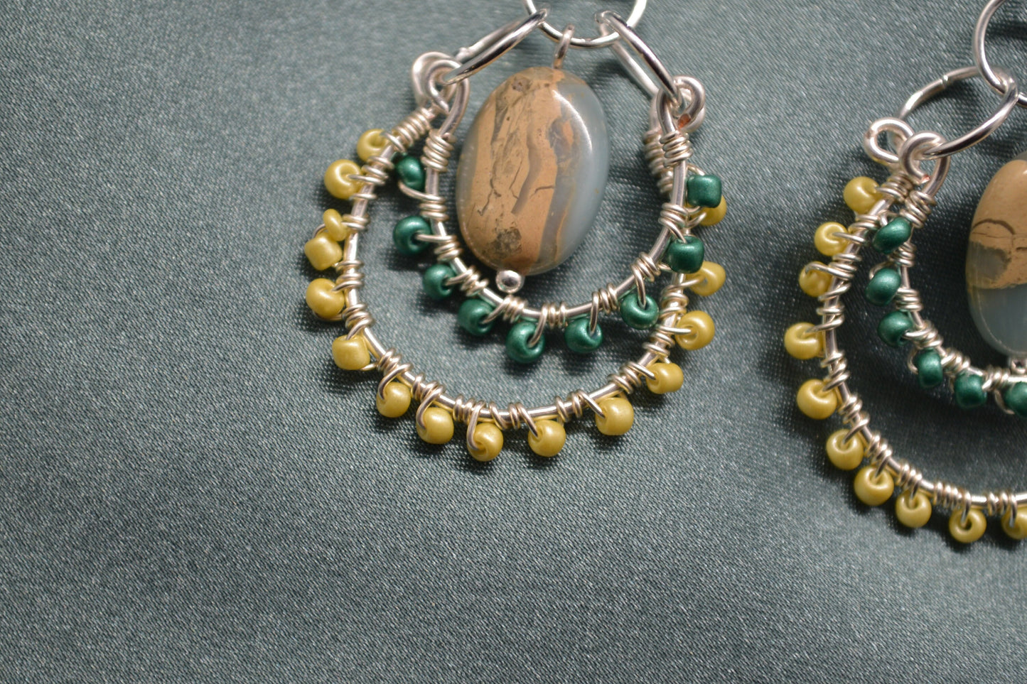 Layered Wire Wrapped Hoop Earrings With Green Center Stone, Green and Yellow accents.