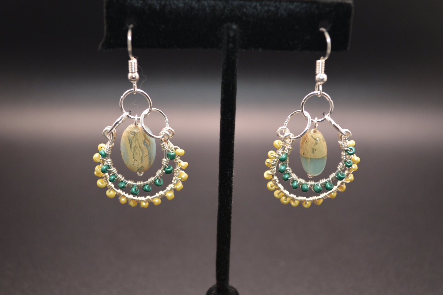 Layered Wire Wrapped Hoop Earrings With Green Center Stone, Green and Yellow accents.